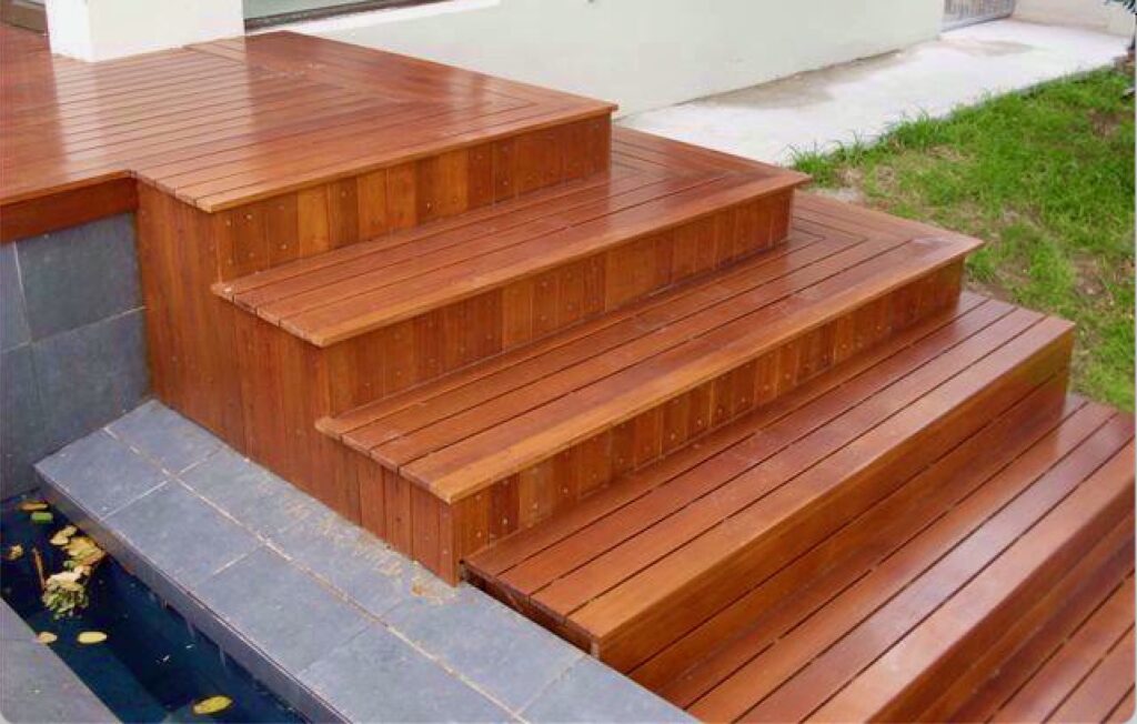Decking stairs built-Balau side of large koi pond constructed rim 'overflow' trough